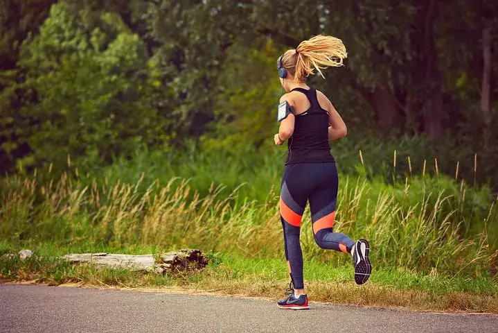 Solo female runner jogging through Phoenix park